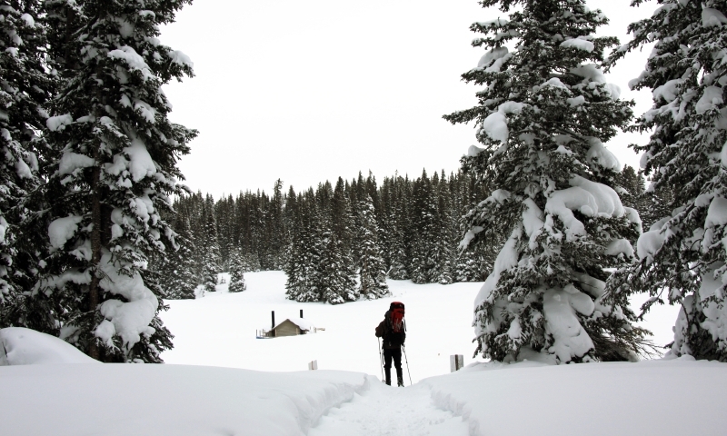 Skier approaches Hut on Vail Pass